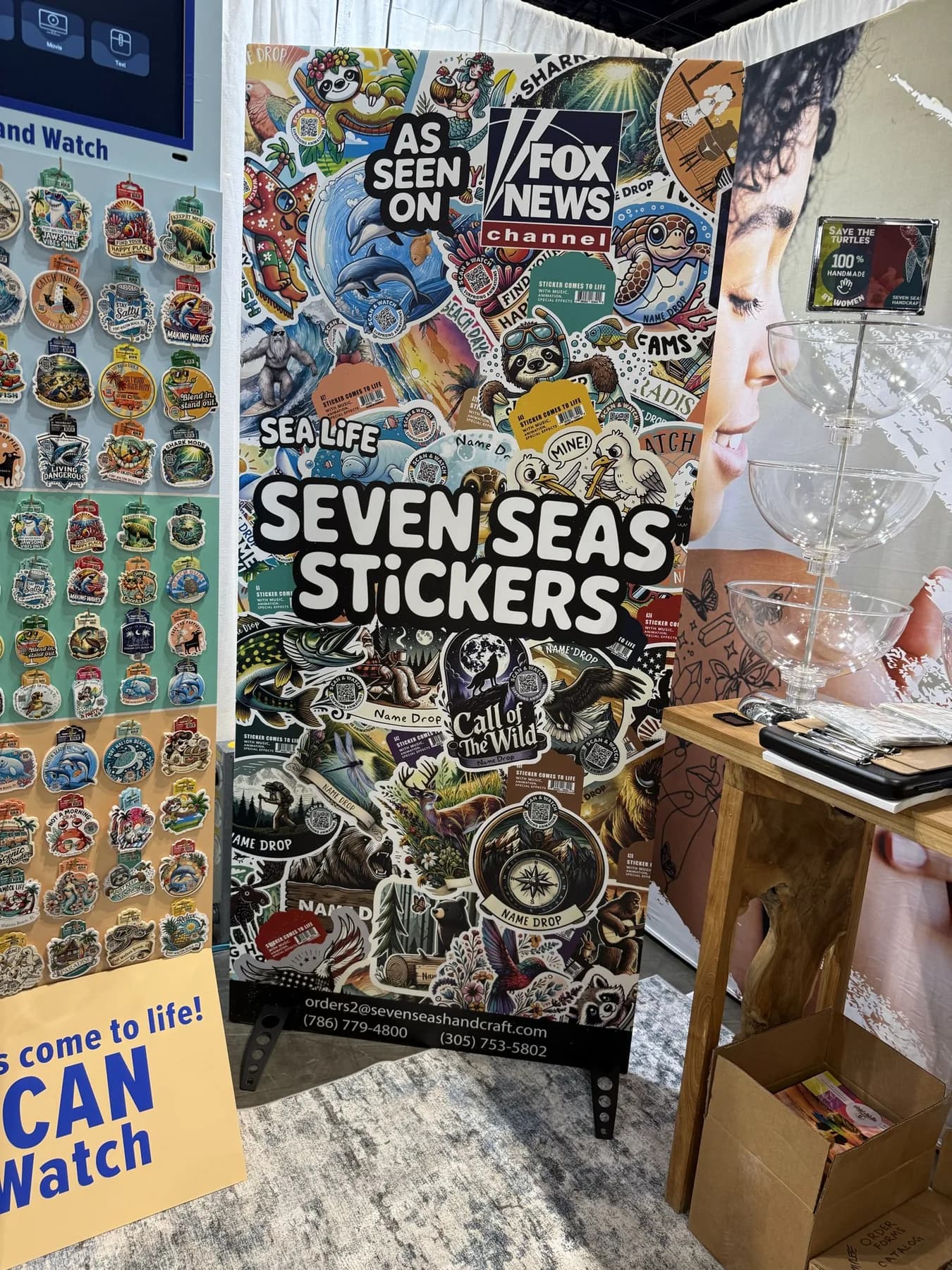 The Seven Seas booth at a trade show, the Sea Life display stocked beside the banner
